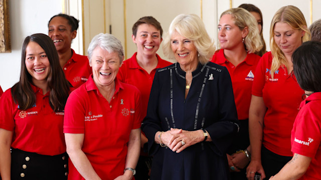 Queen Camila poses for a picture with members of the Maiden Yachting Crew