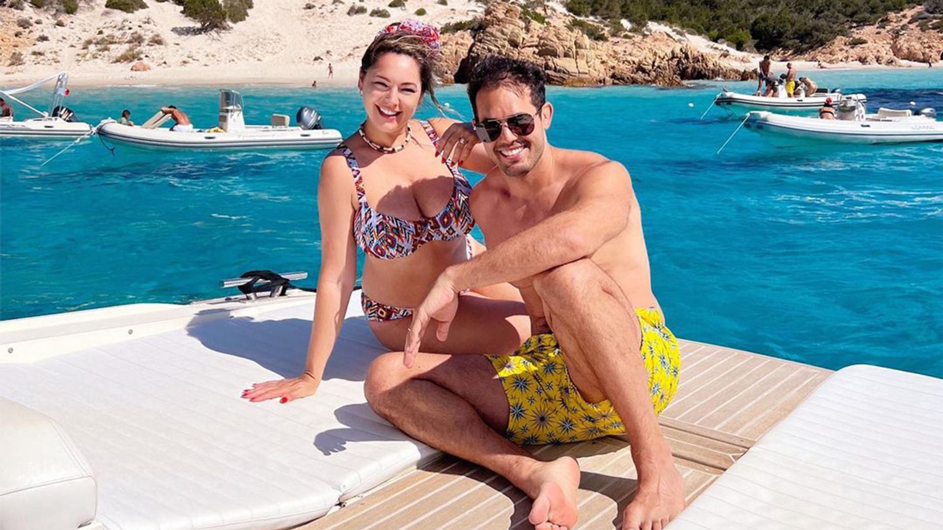 Bikini-clad Kelly Brook smiles as she joins Jeremy on holiday in Sardinia