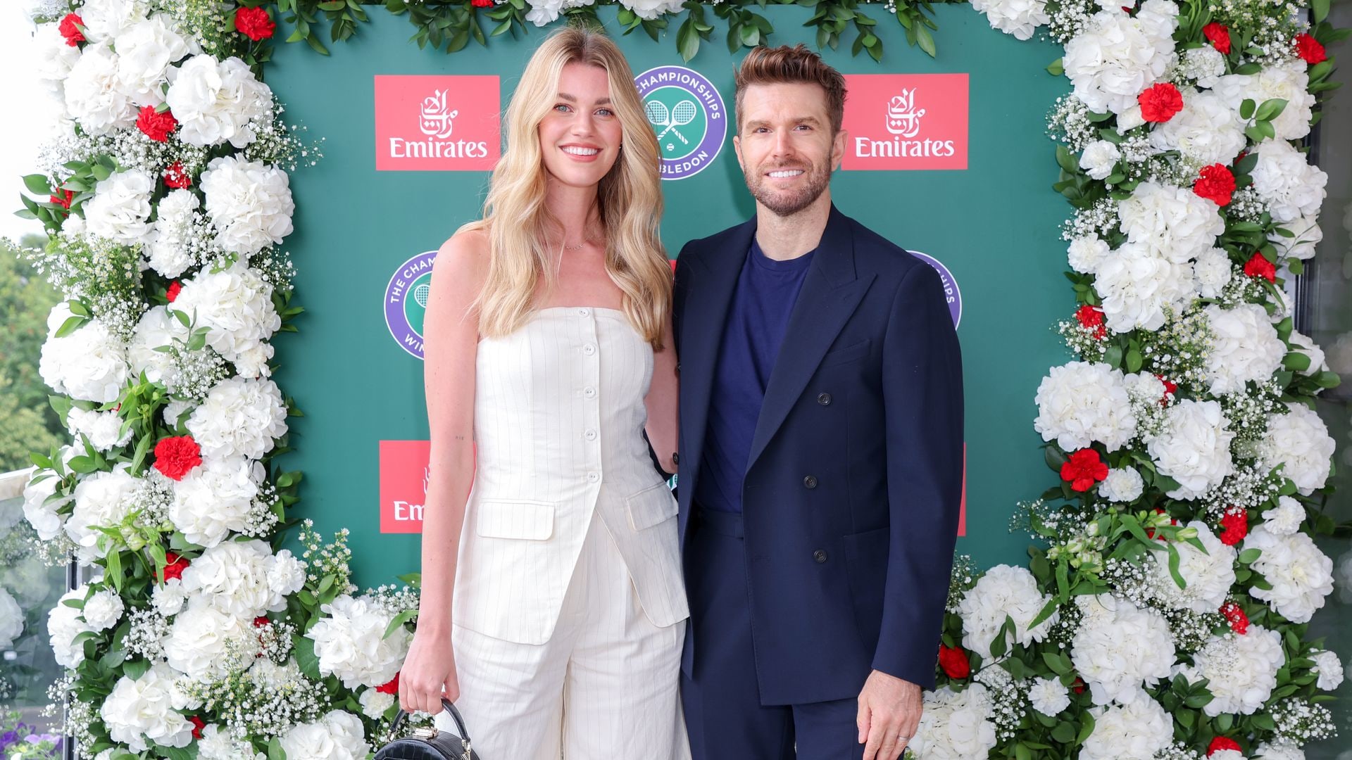 Hannah Cooper in a white dress with Joel Dommett in a blue suit