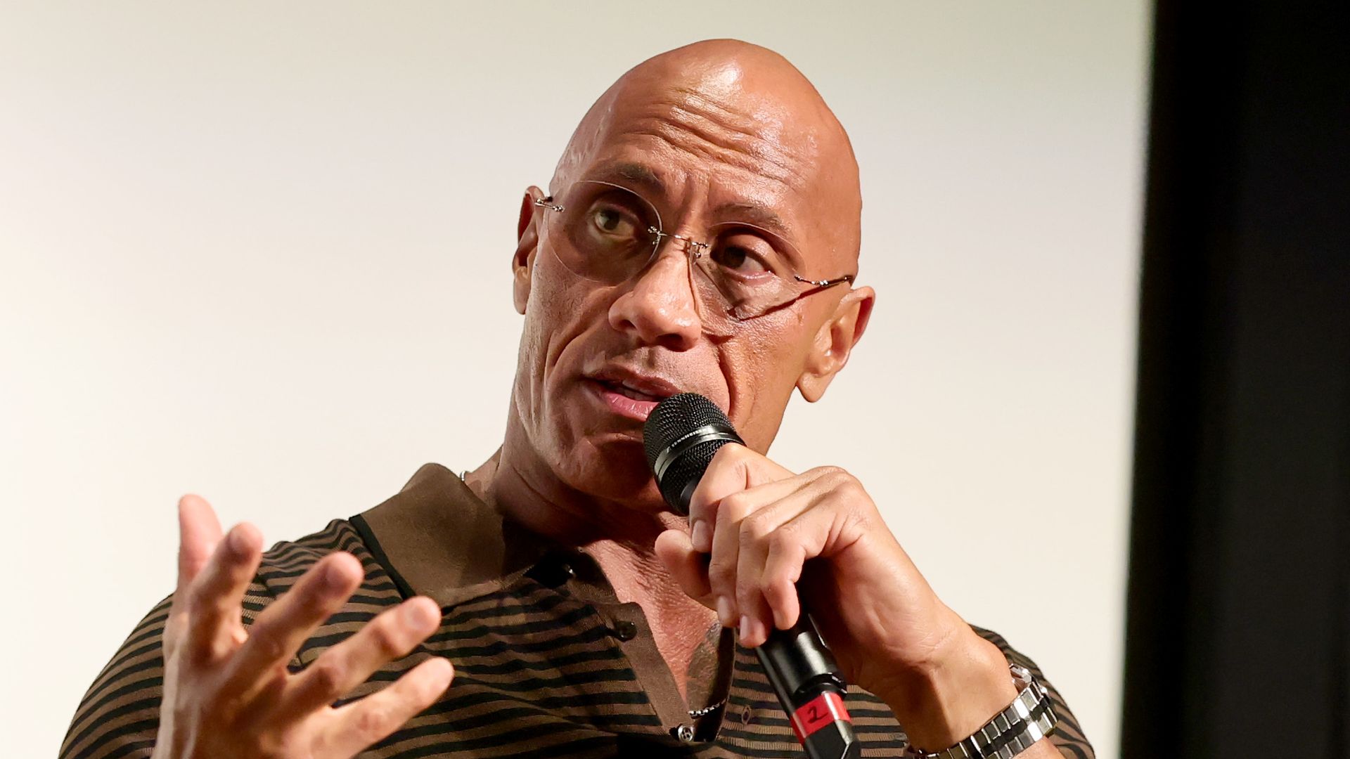 Dwayne Johnson speaking onstage at 'In Conversation With... Dwayne Johnson' during the 2025 Toronto International Film Festival