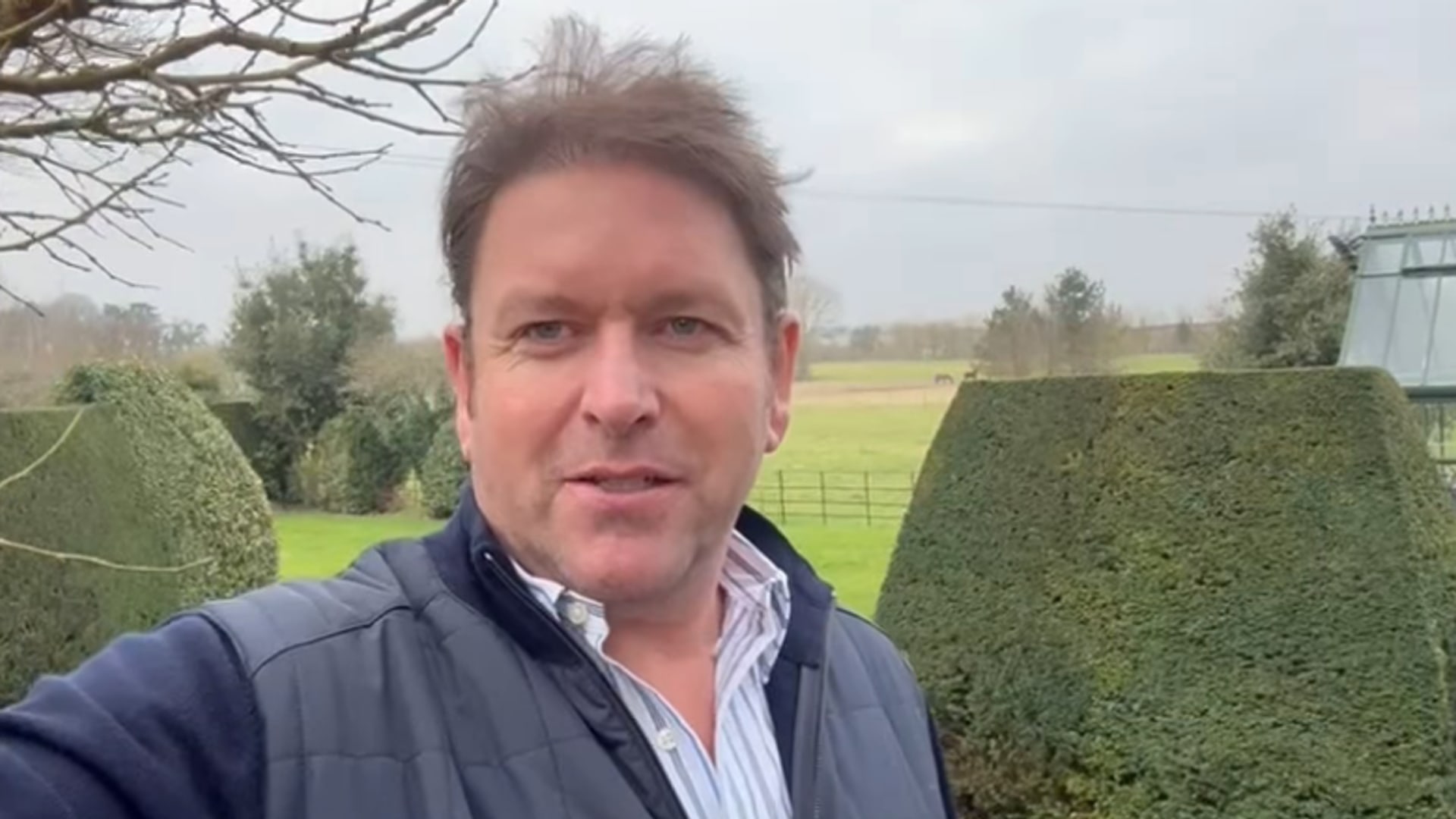James Martin takes a selfie with his garden, greenhouse and tree house in the background