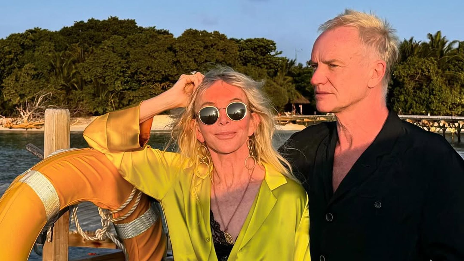 Sting and Trudie Styler stand on a jetty at sunset in the Maldives