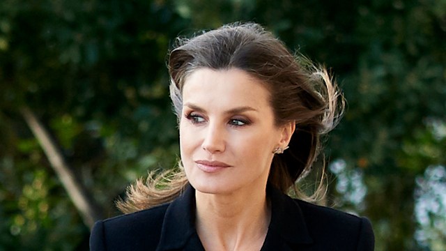 Queen Letizia in black dress holding clutch