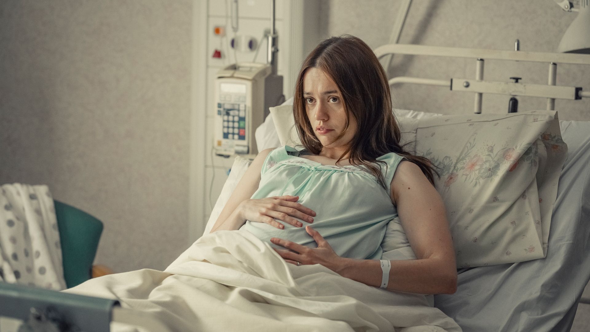 Pregnant woman lying in hospital bed