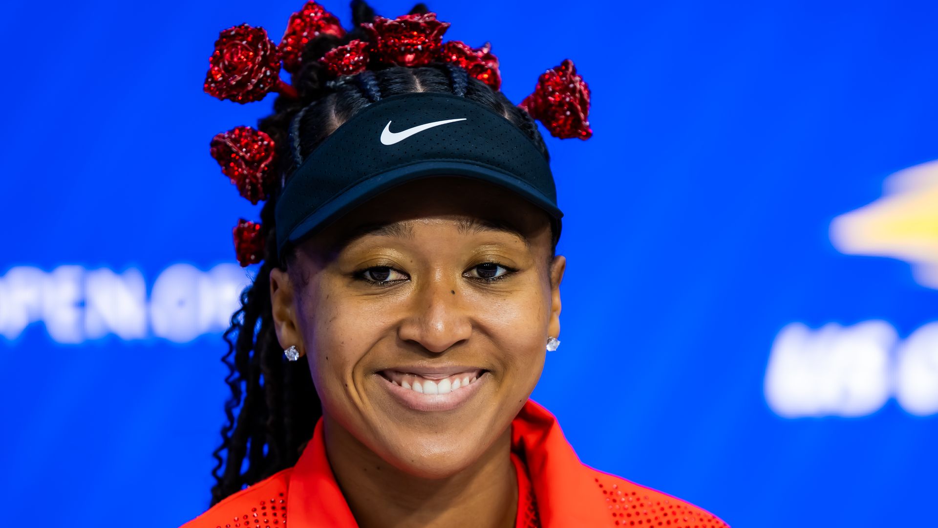 Naomi Osaka of talks to the media after defeating Greet Minnen of Belgium at the US Open 
