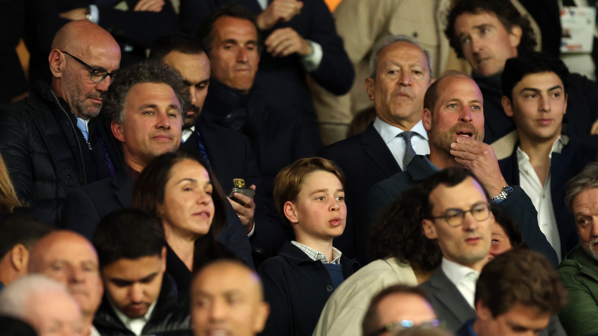 Thomas van Straubenzee, Prince George of Wales and Prince William, Prince of Wales react from the stands during the UEFA Champions League 2024/25 Quarter Final First Leg match between Paris Saint-Germain and Aston Villa FC at Parc des Princes on April 09, 2025 in Paris, France