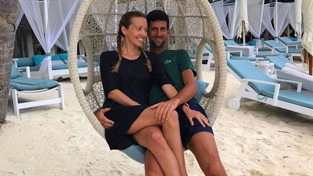 Novak Djokovic and Jelena sitting on a hanging seat while on vacation