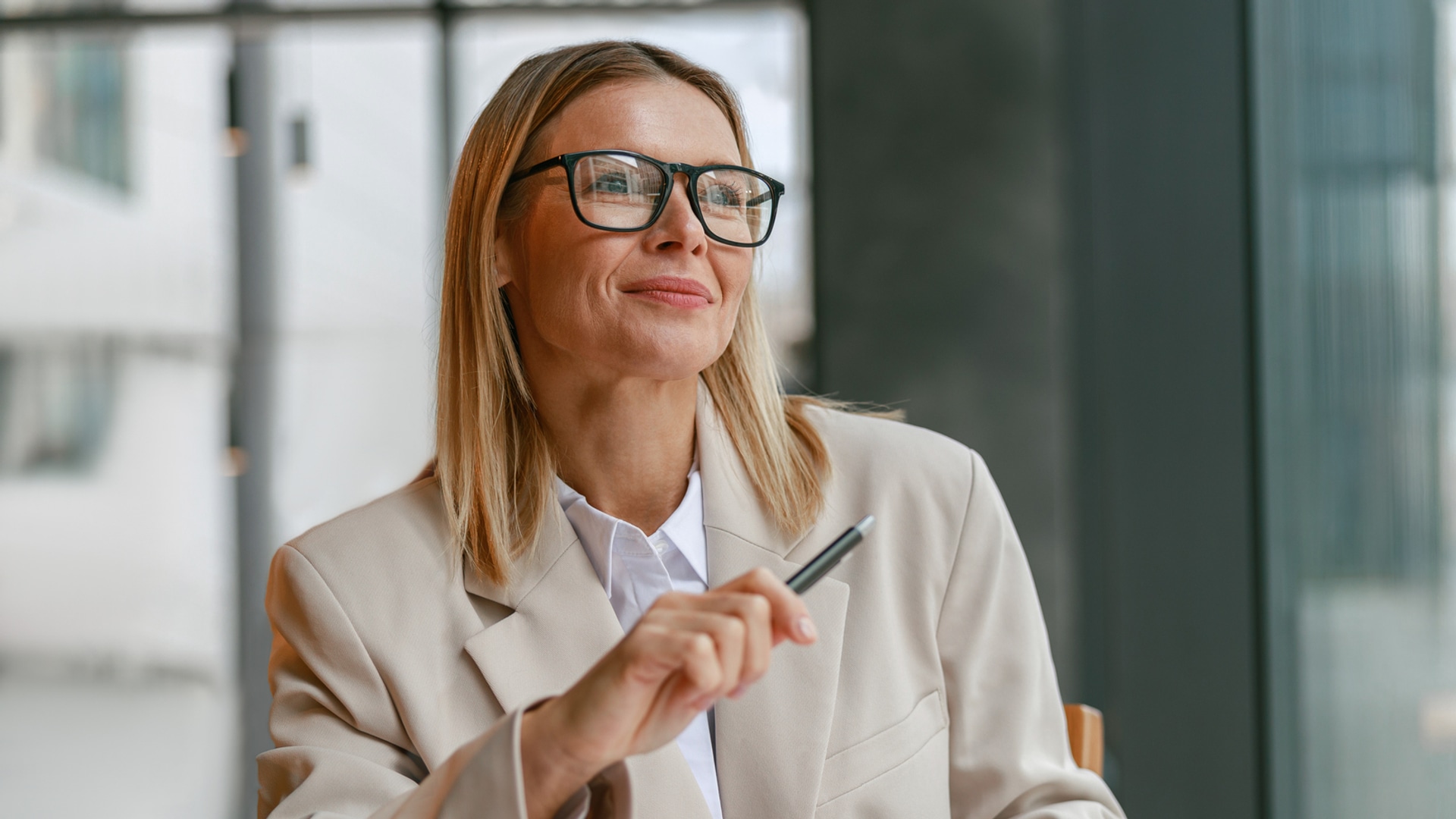 blonde woman with glasses proposing ideas