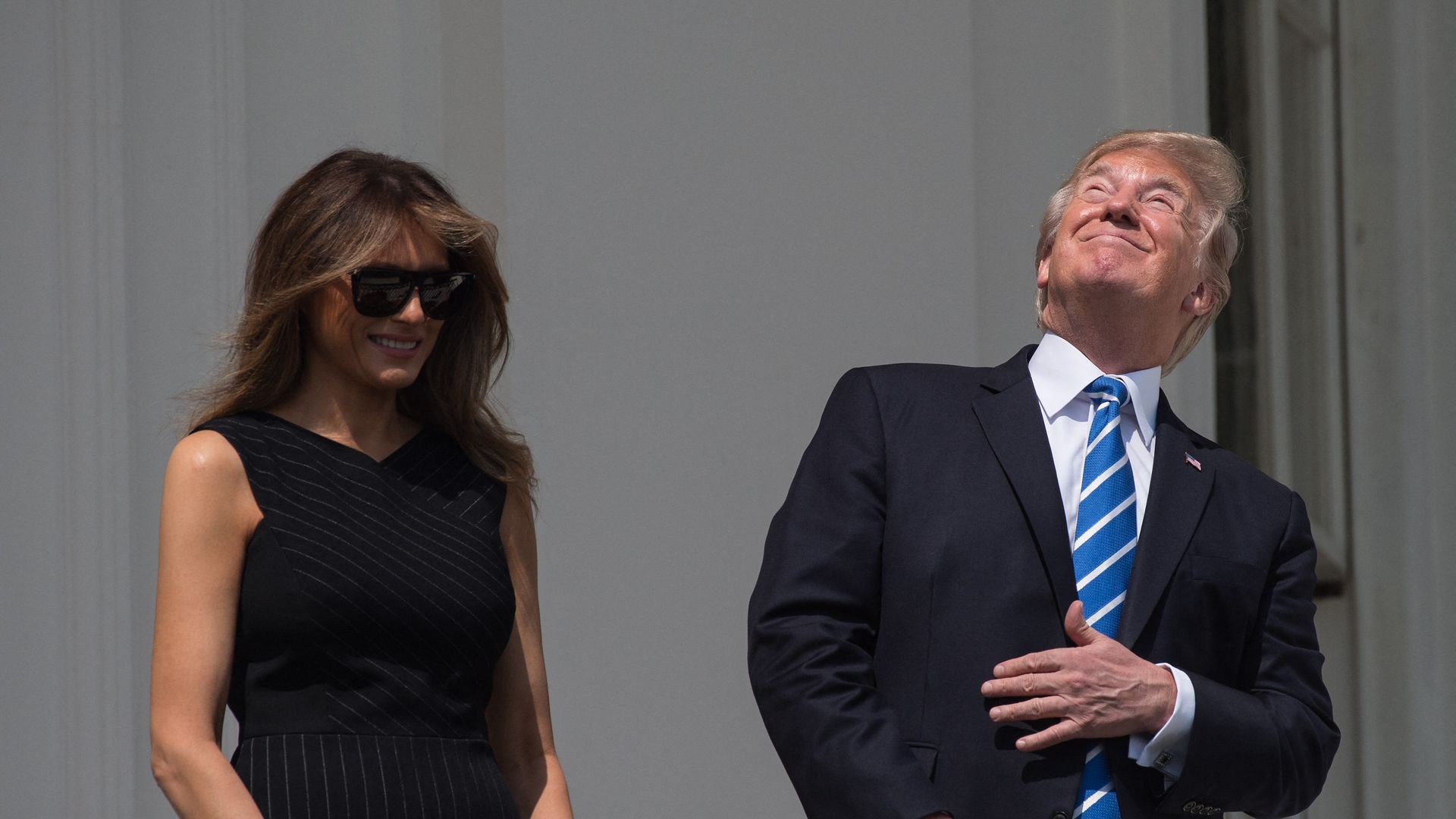US President Donald Trump and First Lady Melania Trump look up at the partial solar eclipse from the balcony of the White House in Washington, DC, on August 21, 2017