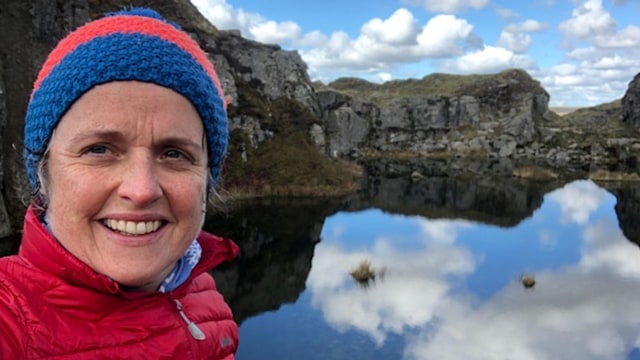 woman in hat by lake