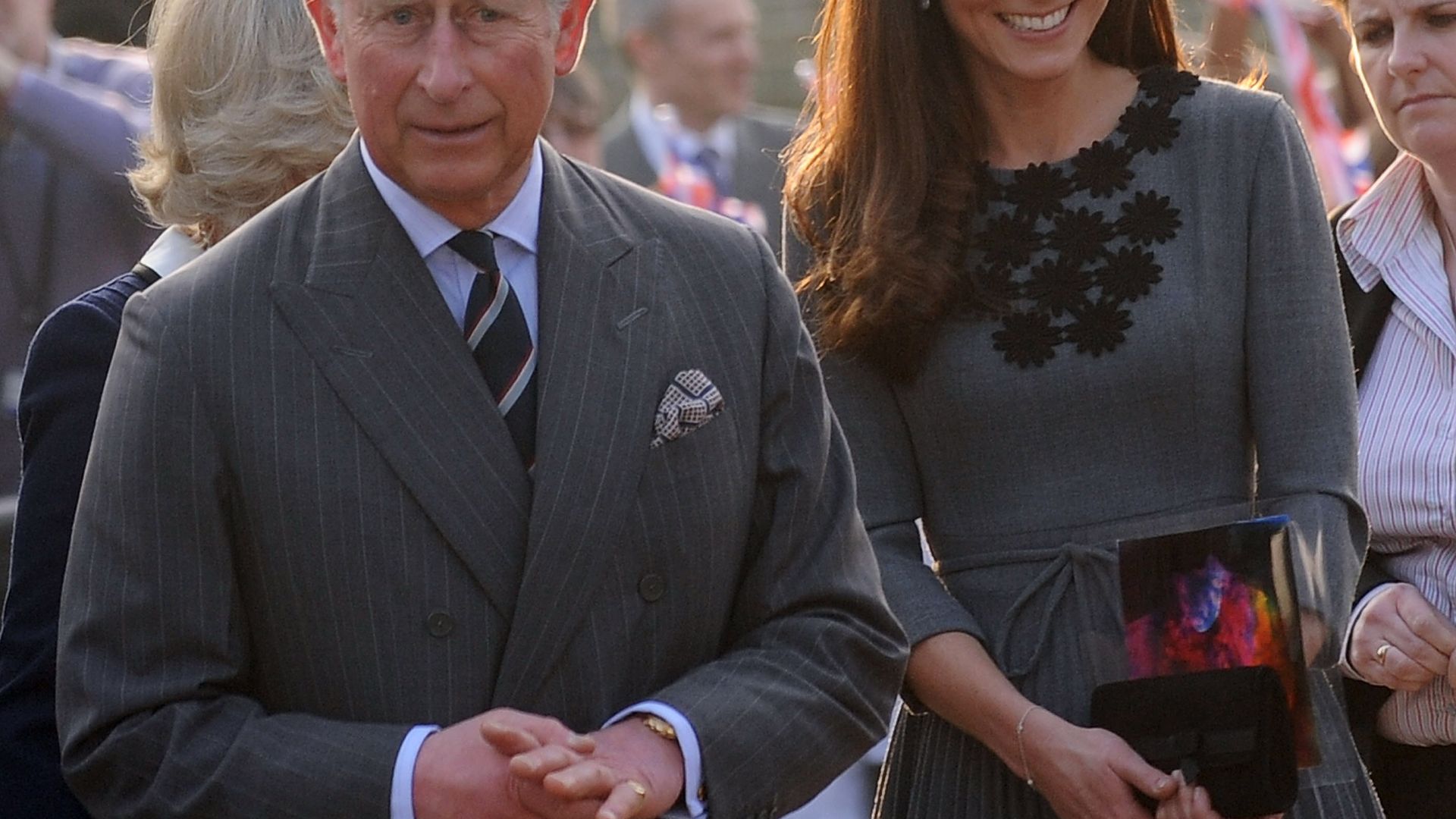 Charles wears a grey suit as smiling Princess Kate keeps him company
