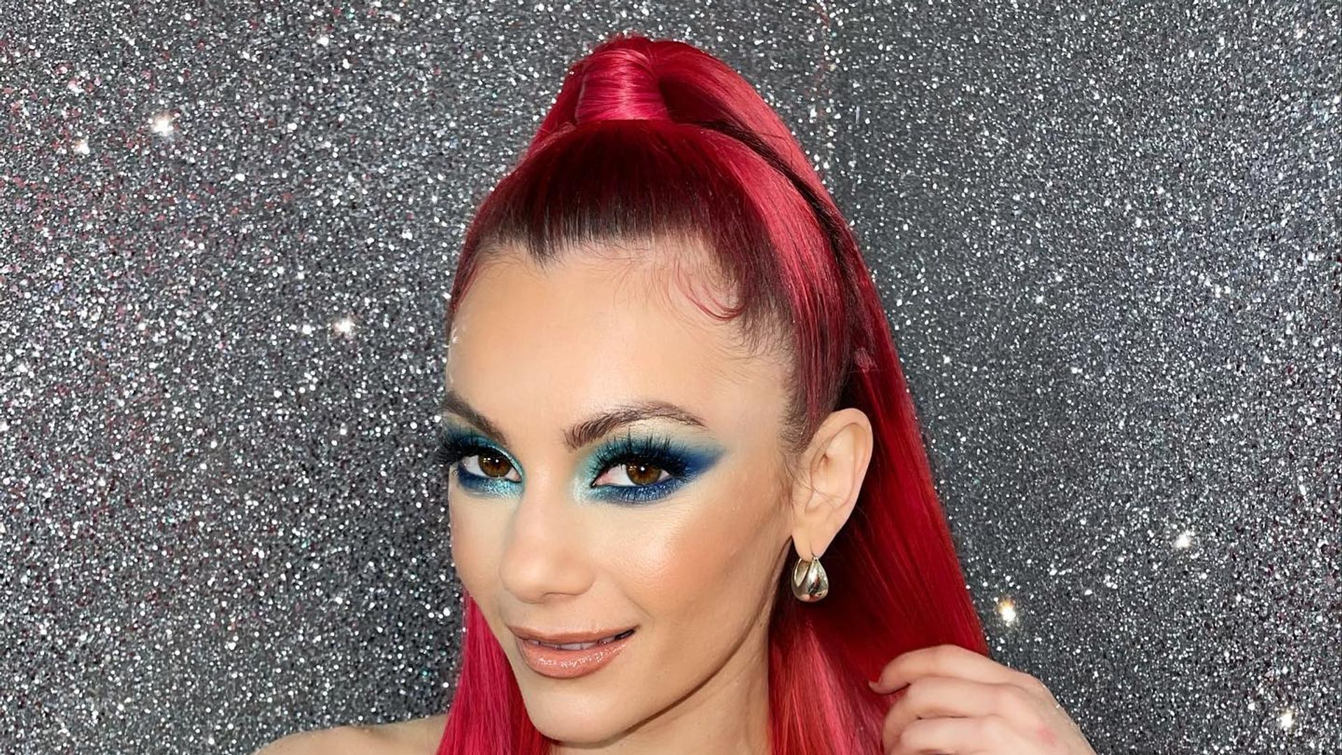 Dianne with straight red hair in blue jumpsuit