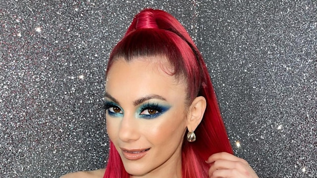 Dianne with straight red hair in blue jumpsuit