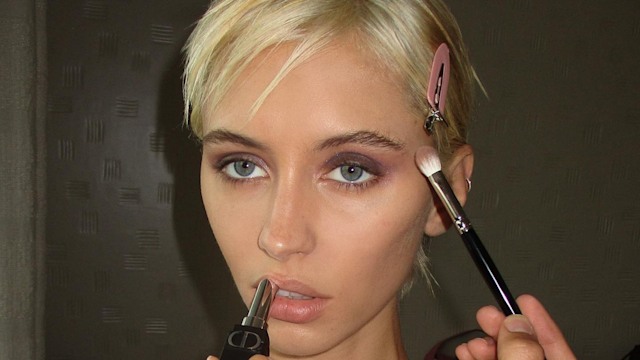 Iris Law poses while getting her makeup done