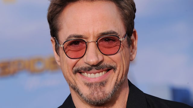 Robert Downey Jr. smiling in a suit