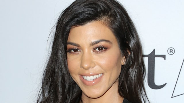 Kourtney Kardashian smiling in black