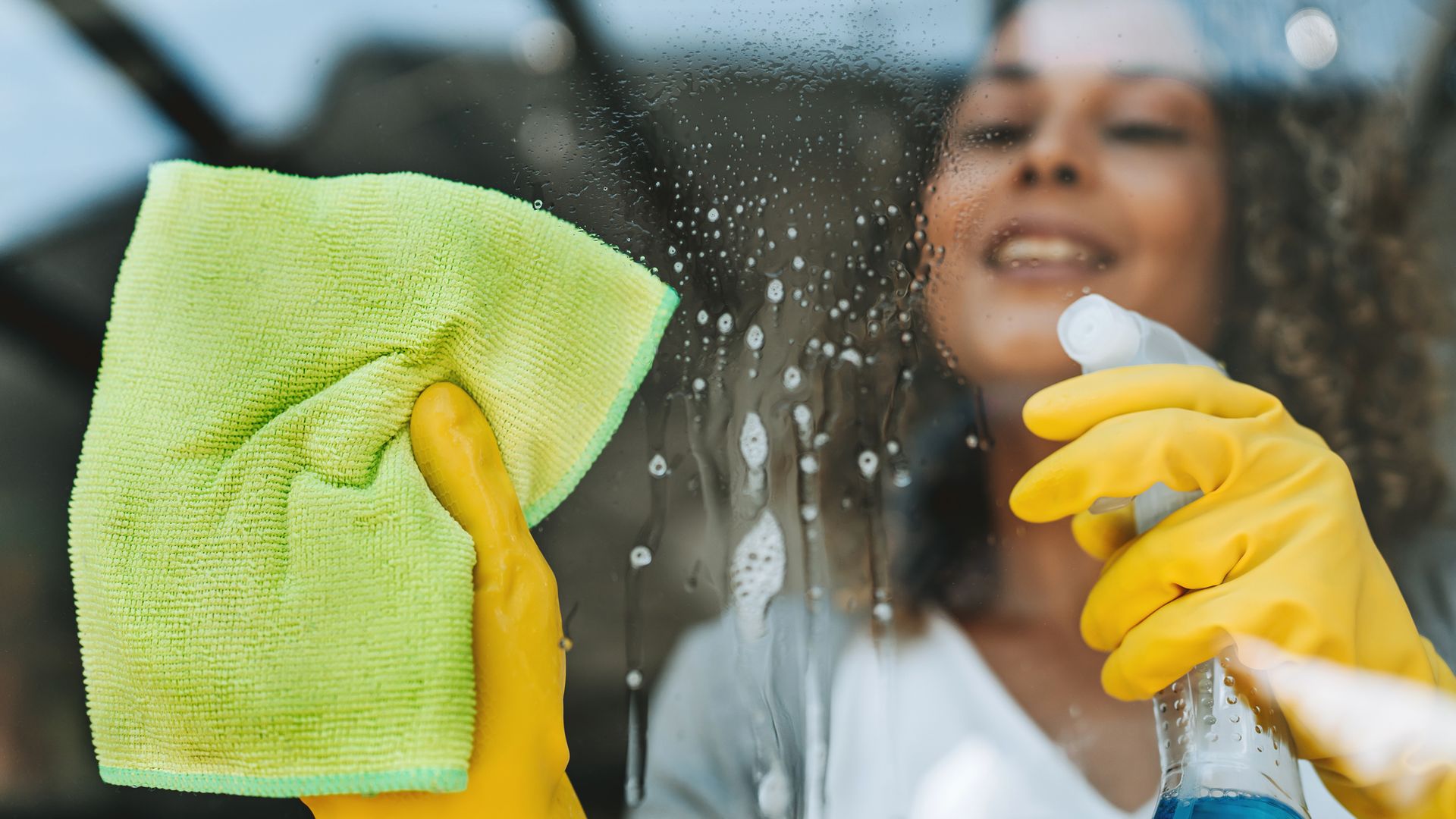 A woman cleaning house windows