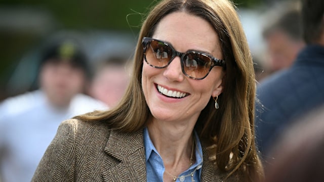 Kate Middleton wearing sunglasses, checked blazer and blue shirt