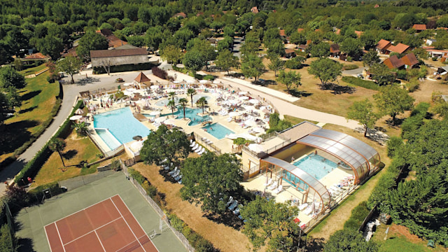 Aerial view of campsite with swimming pools and tennis courts