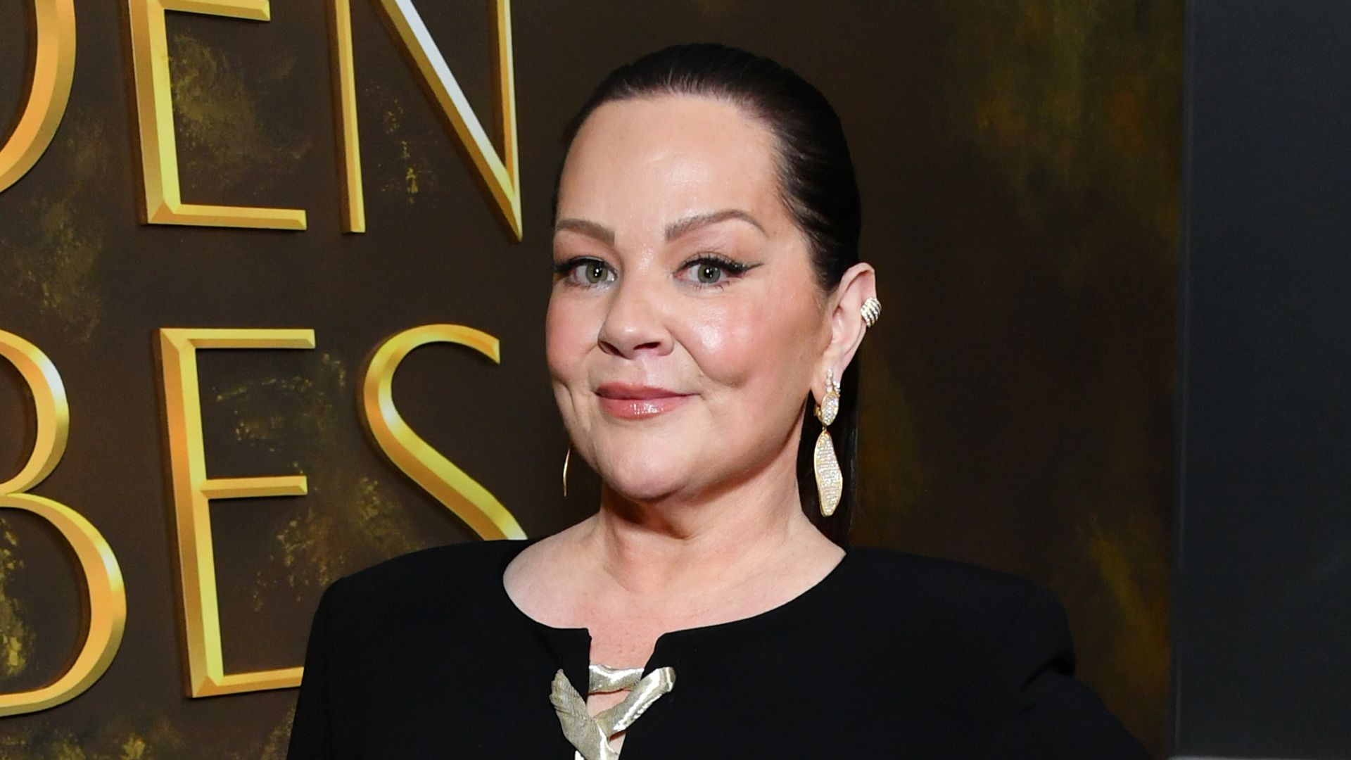 Melissa McCarthy looks incredible in curve-skimming gown and sleek ponytail for Golden Globes