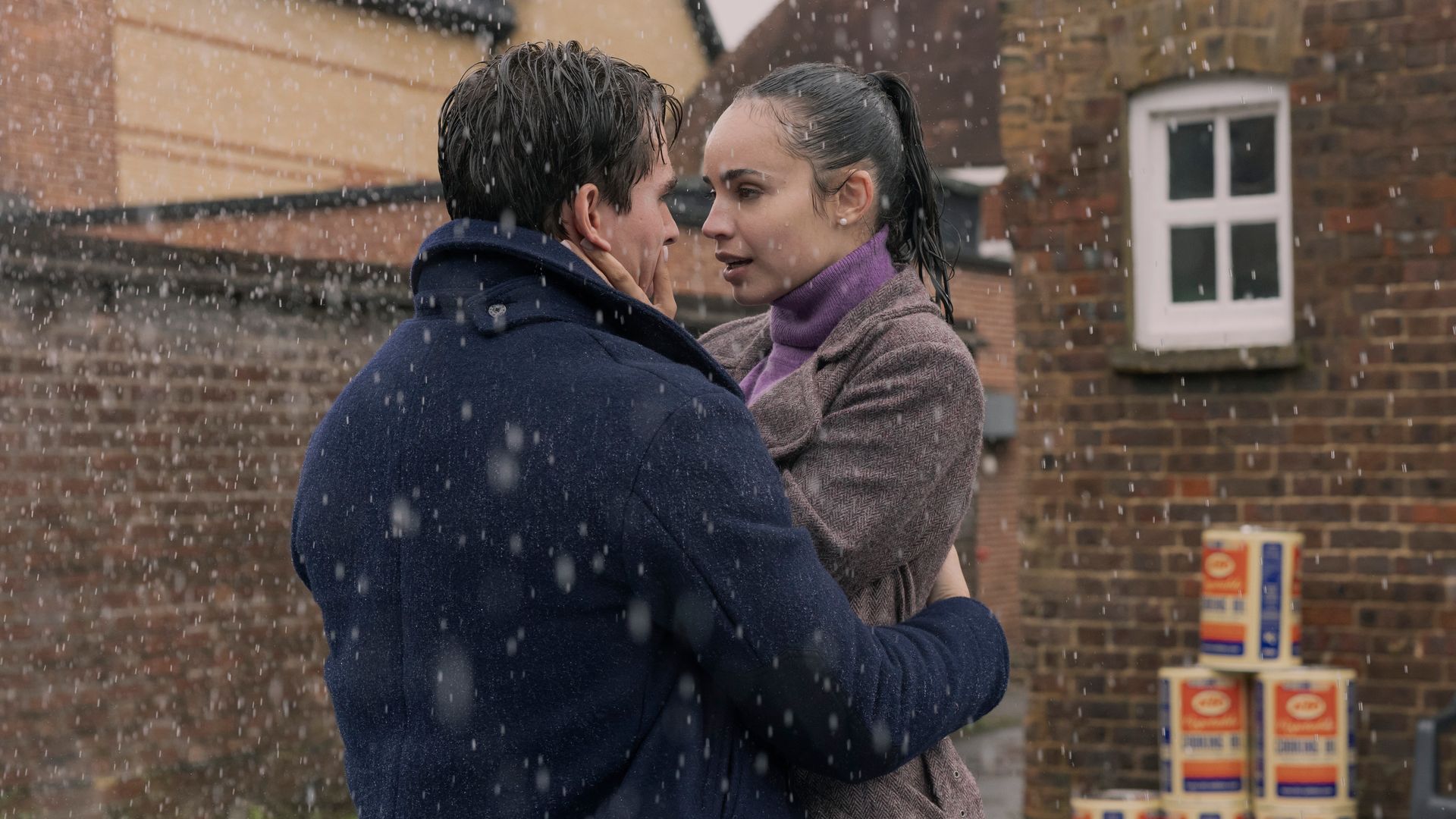 man and woman hugging in rain