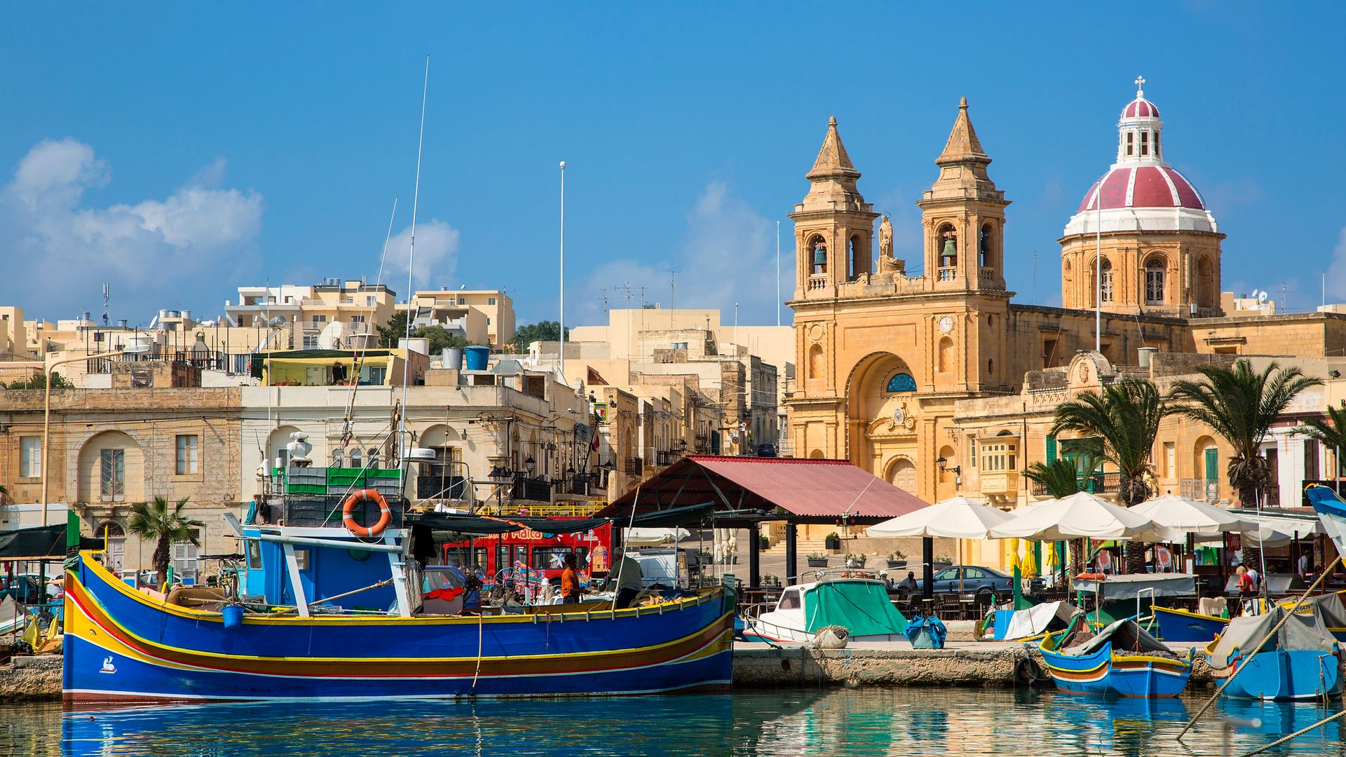 Malta, Marsaxlokk, fishing village harbour on the south coast with colourful Kajjiki fishing boats and the Church dedicated to Our Lady of the Rosary The Madonna of Pompeii.