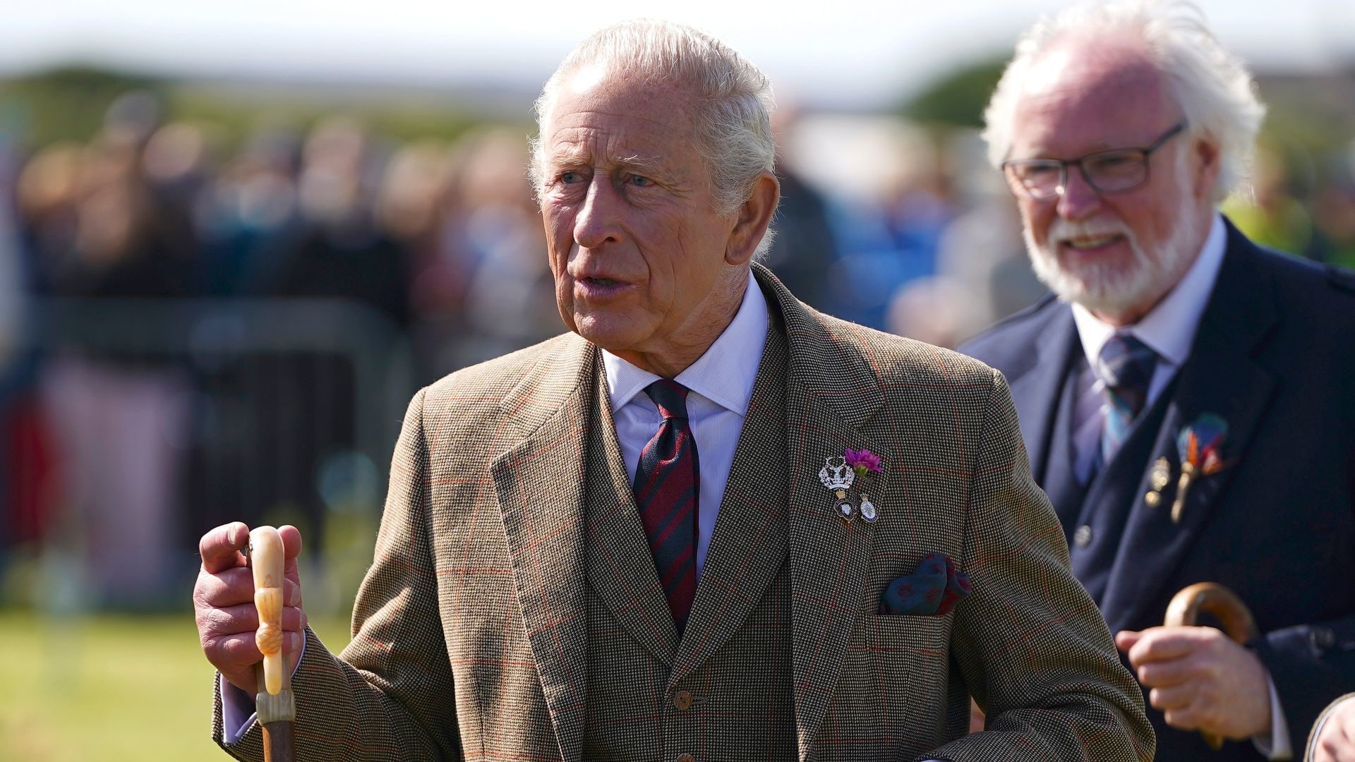 King Charles walking with a walking stick