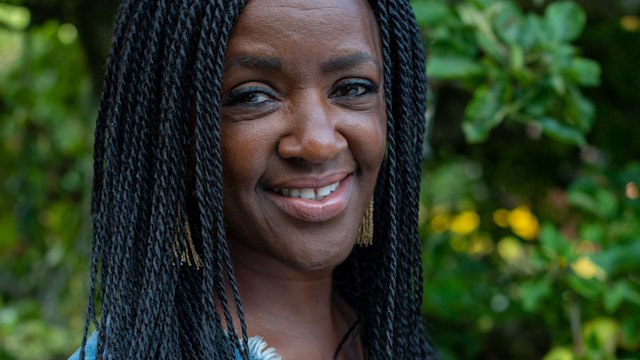 Diane Louise Jordan poses with leafy backdrop