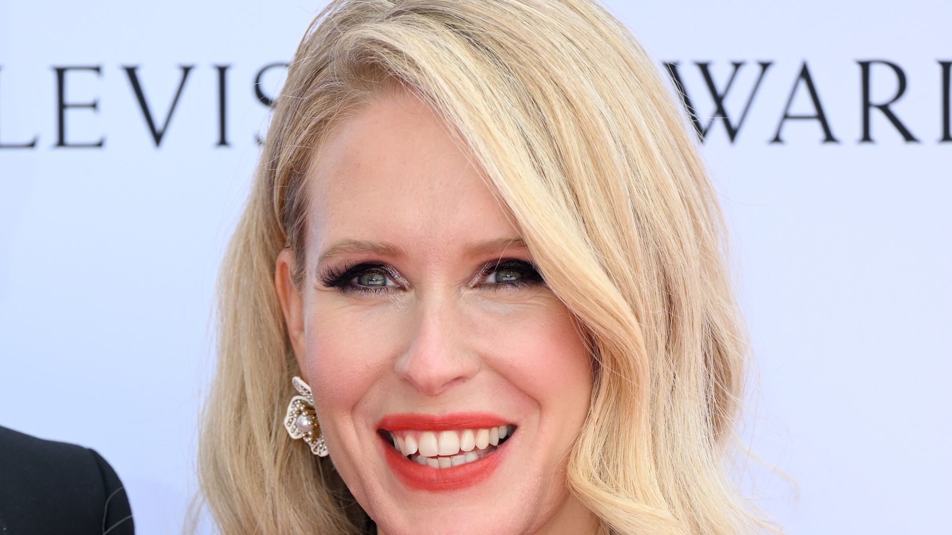 Lucy Beaumont in a black halterneck dress