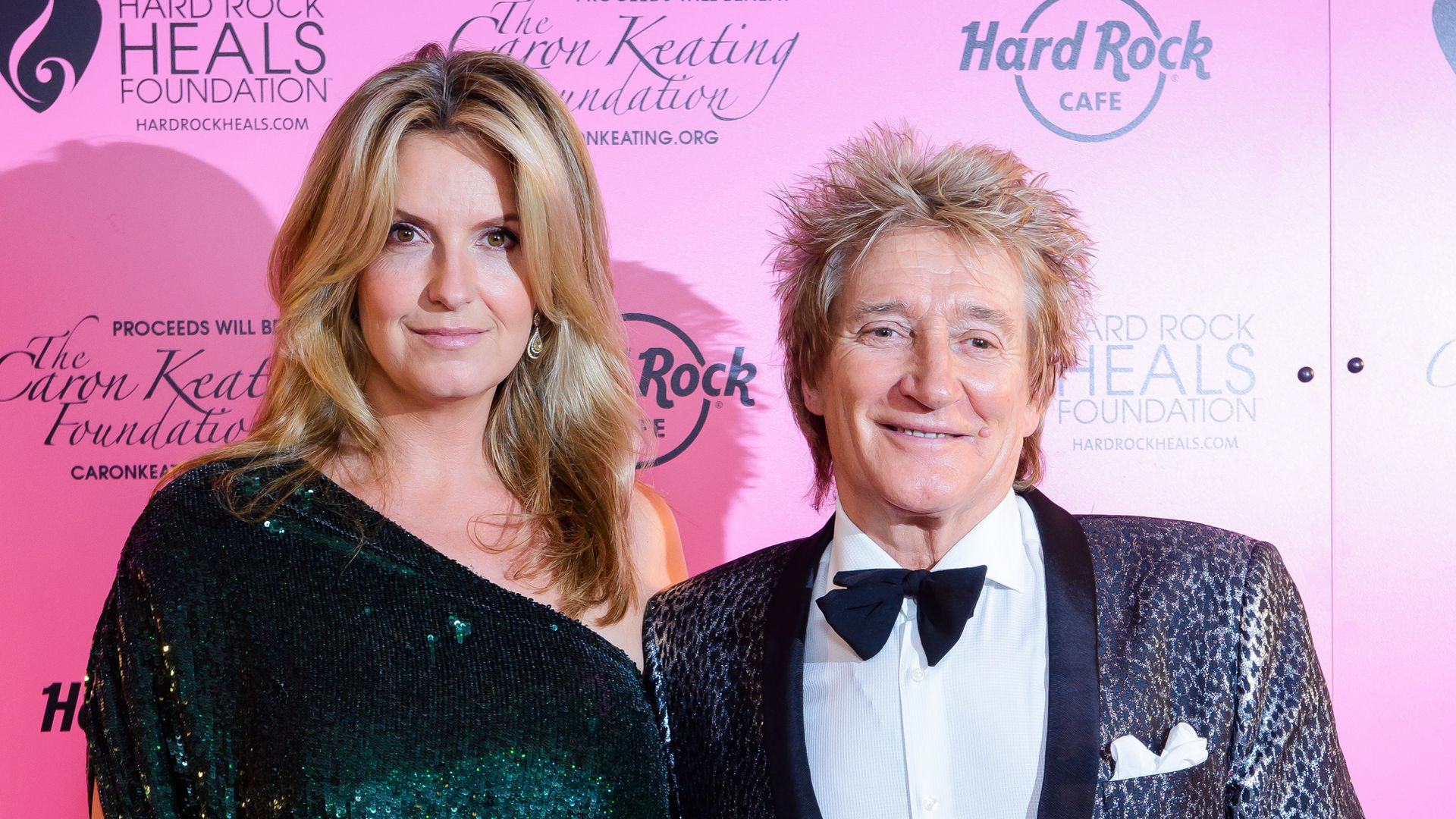 Penny Lancaster in glittery mini dress and Rod Stewart in suit