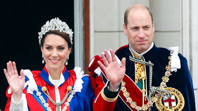 Princess Kate and Prince William in their coronation outfits waving from Buckingham Palace's balcony