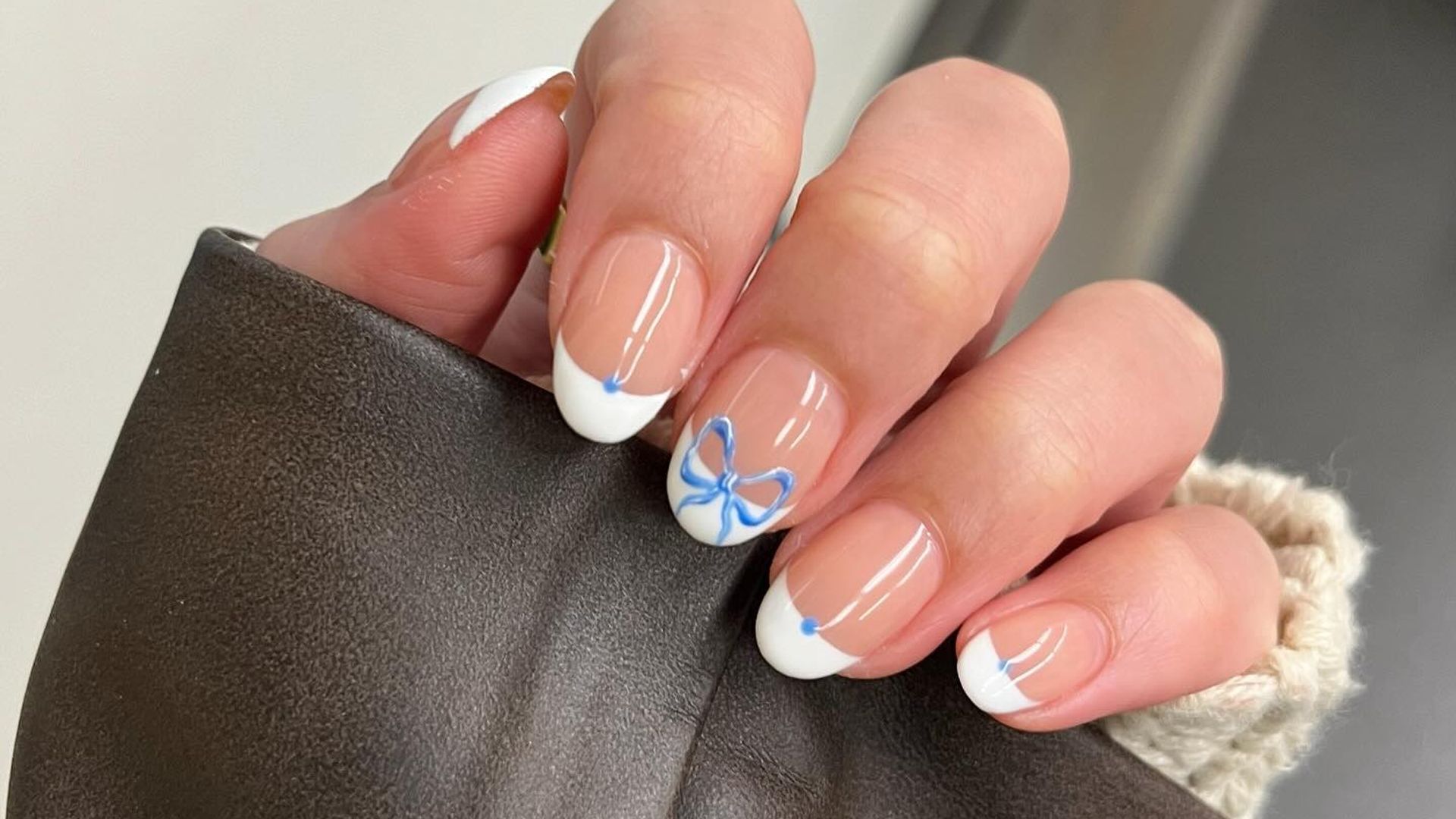 French tipped manicure with hand painted blue bows