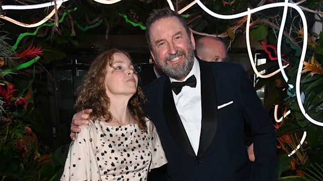 Tara McKillop in spotted dress standing with Lee Mack in a tuxedo