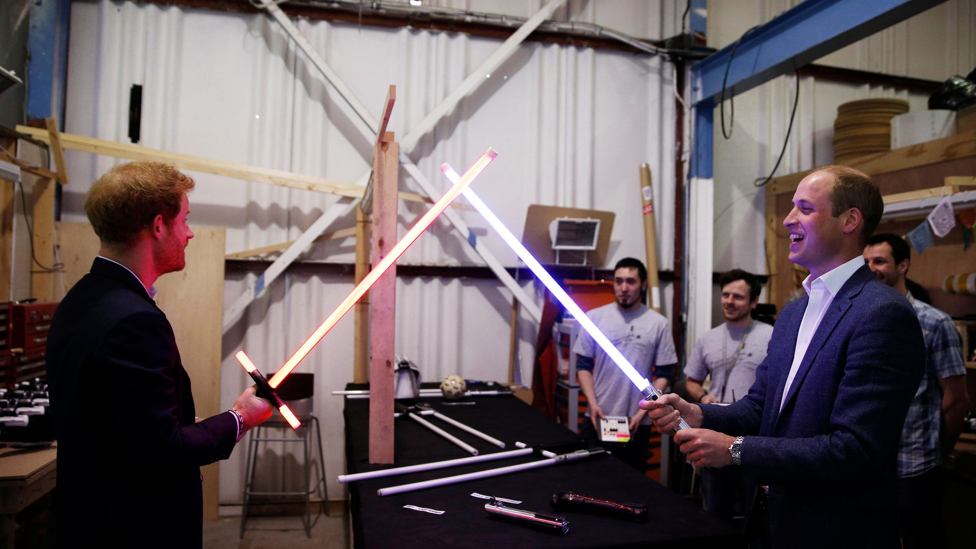Prince WIlliam and Prince Harry duelling with lightsabers