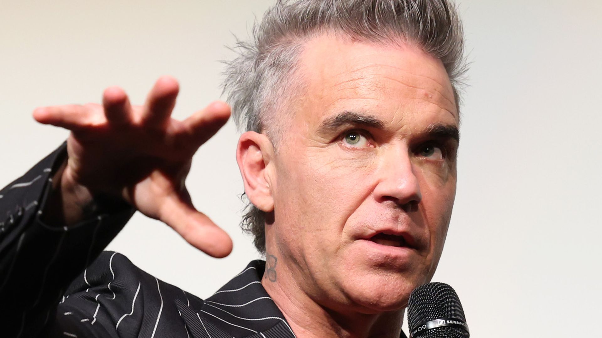 TORONTO, ONTARIO - SEPTEMBER 09: Robbie Williams speaks onstage during the "Better Man" Canadian Premiere at the Toronto International Film Festival at Roy Thomson Hall on September 09, 2024, in Toronto, Ontario. (Photo by Monica Schipper/Getty Images for Paramount Pictures)
