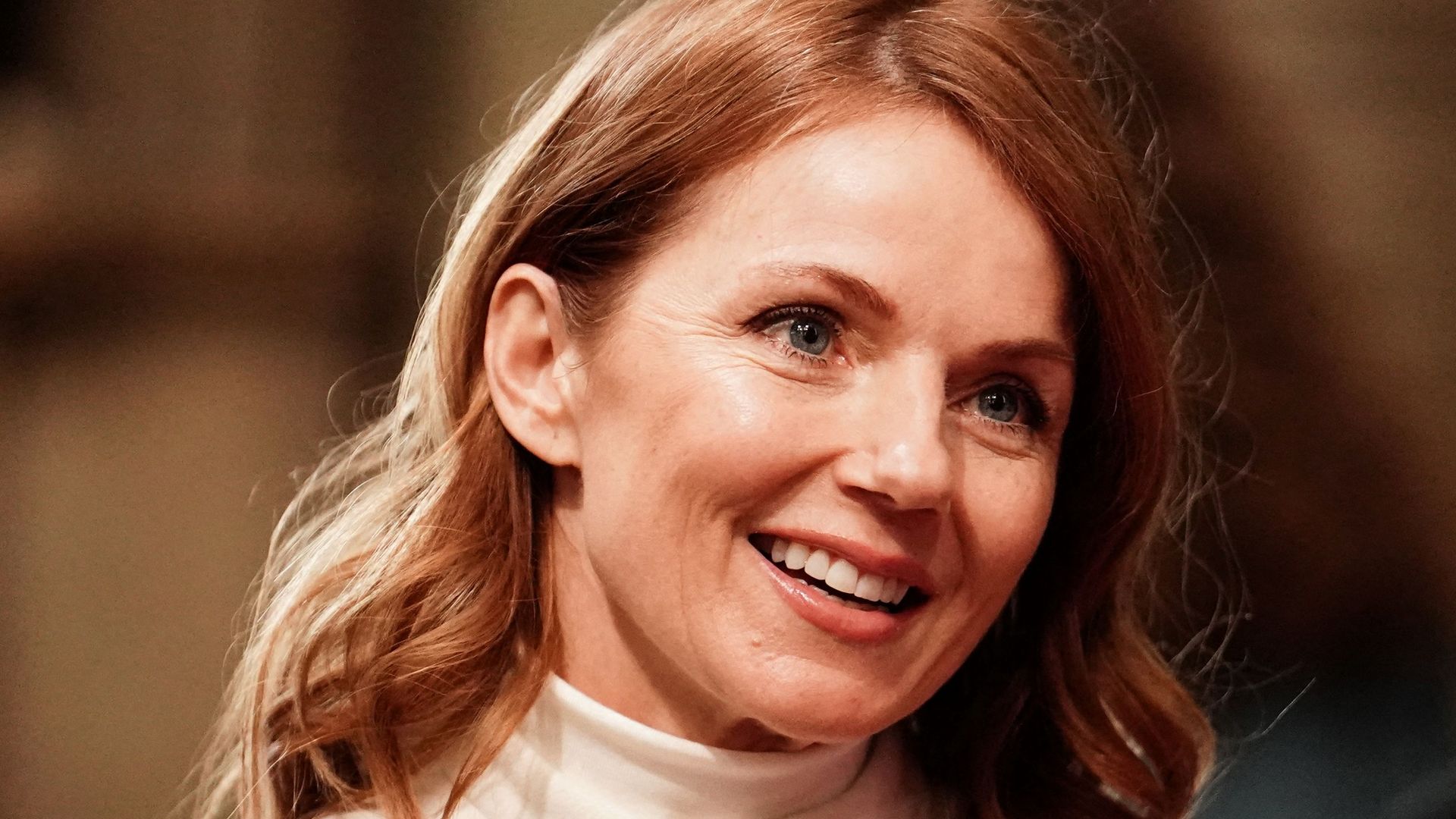 Geri Horner Halliwell wearing white and smiling at Commonwealth Day service ceremony