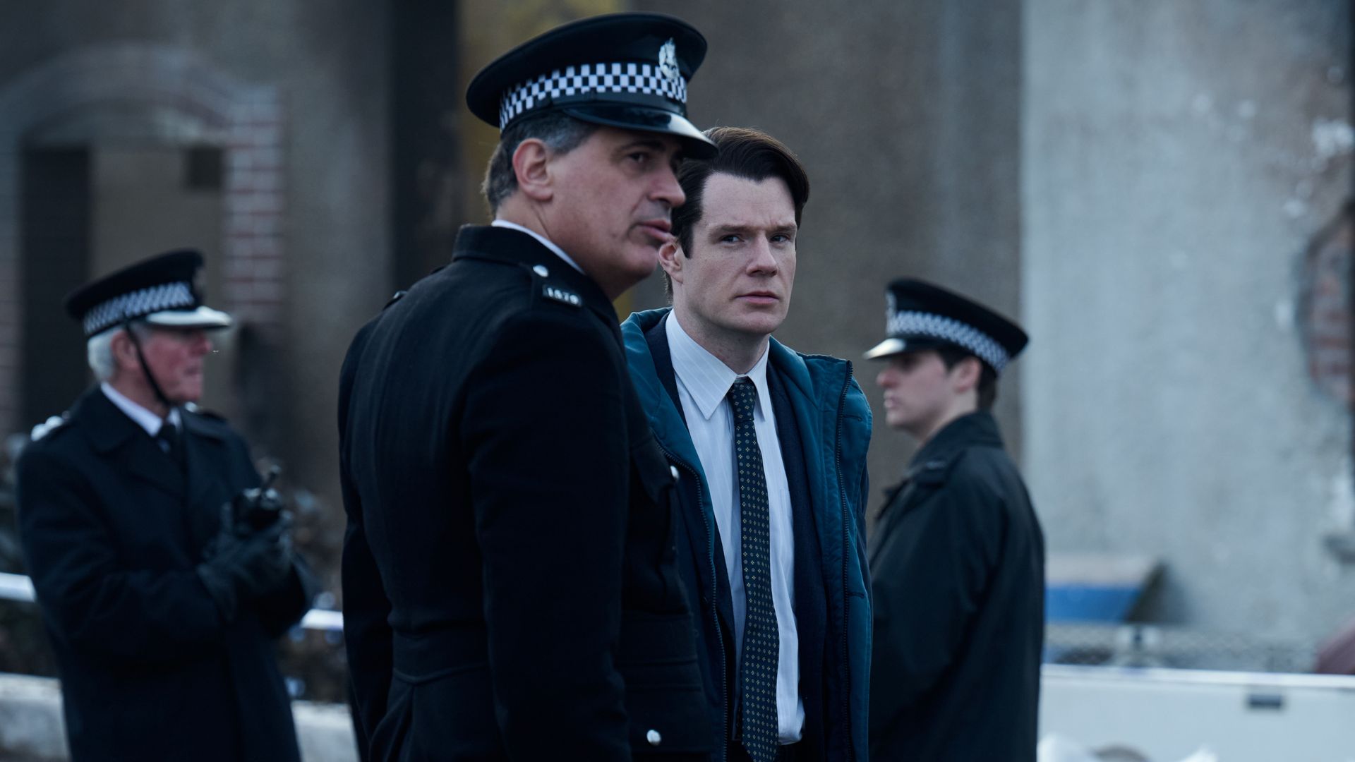 police officers standing next to police tape