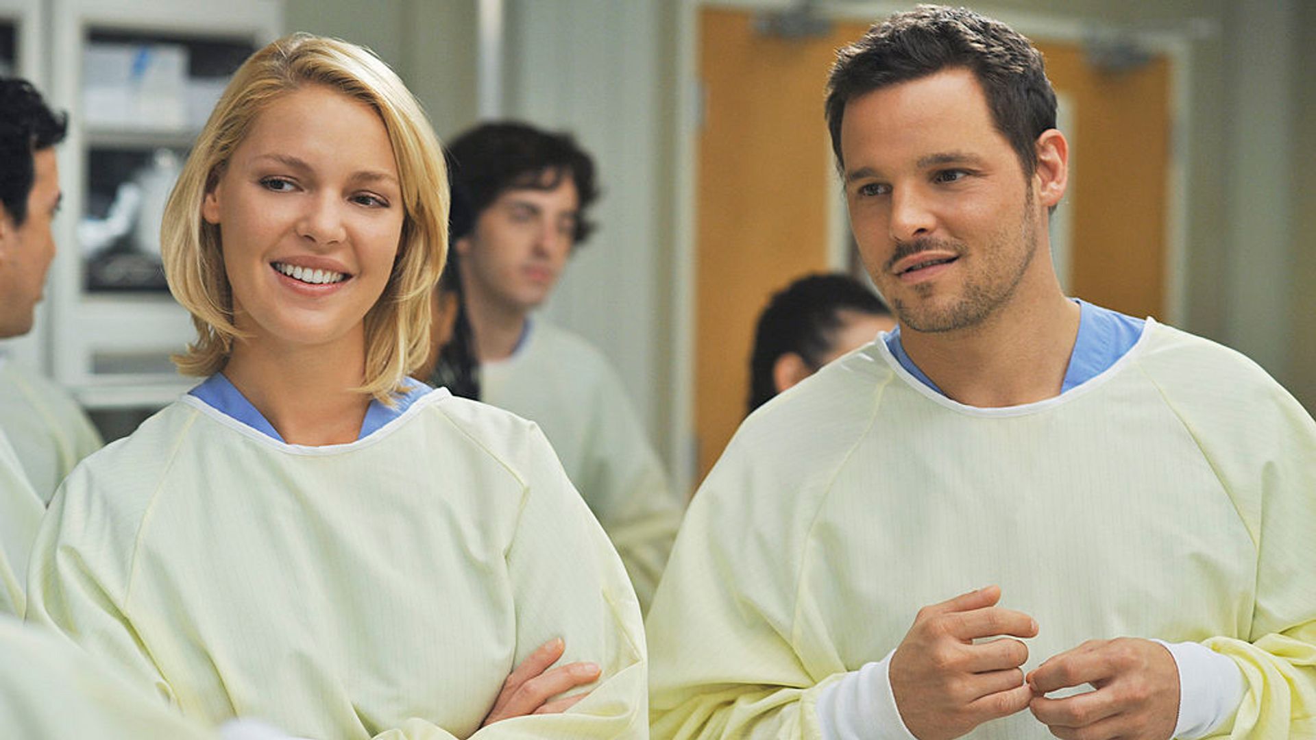 Alex and Izzie laughing together in Grey's Anatomy. 