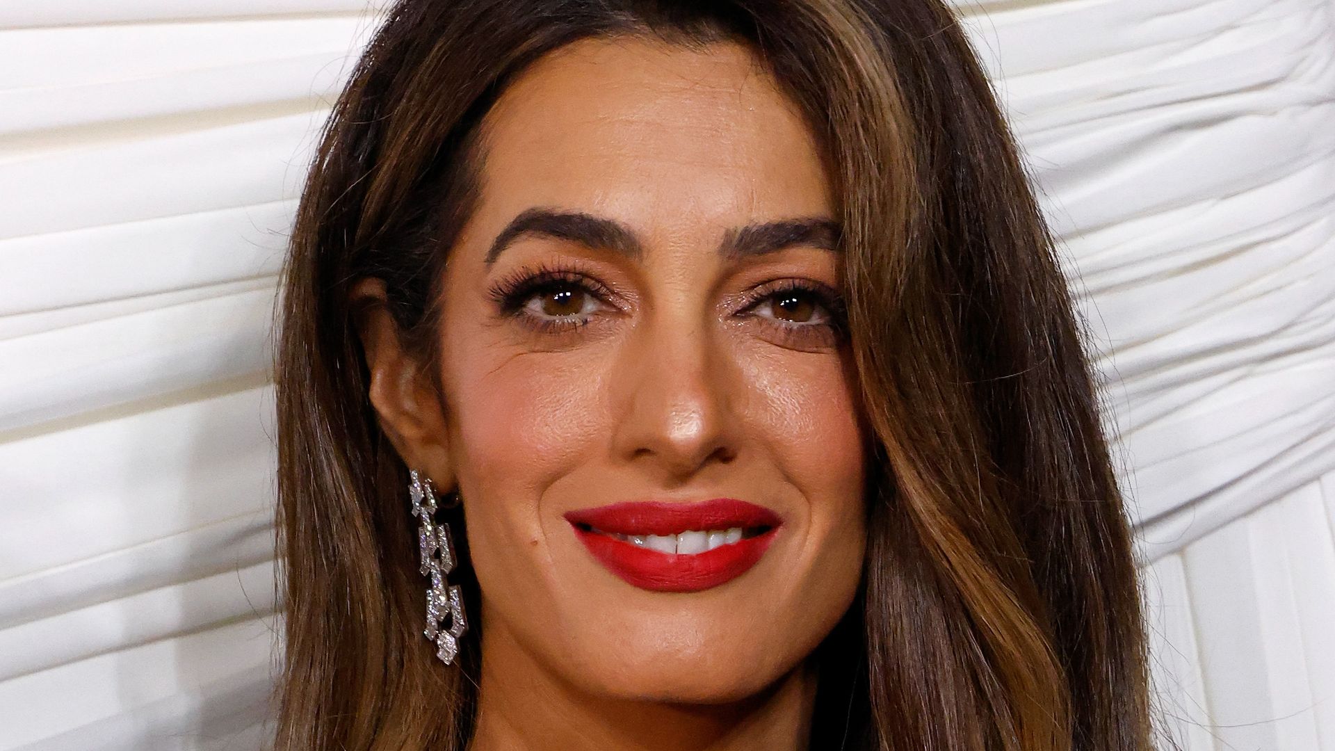 Amal Clooney shoulders up in black dress