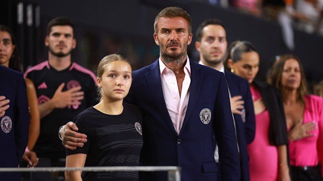 David Beckham looks proud as he wraps his arm around his daughter Harper