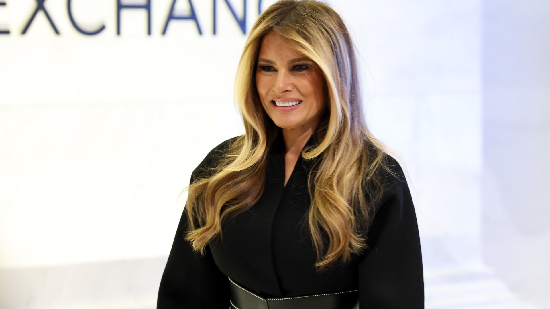 Melania Trump in black coat dress with belt