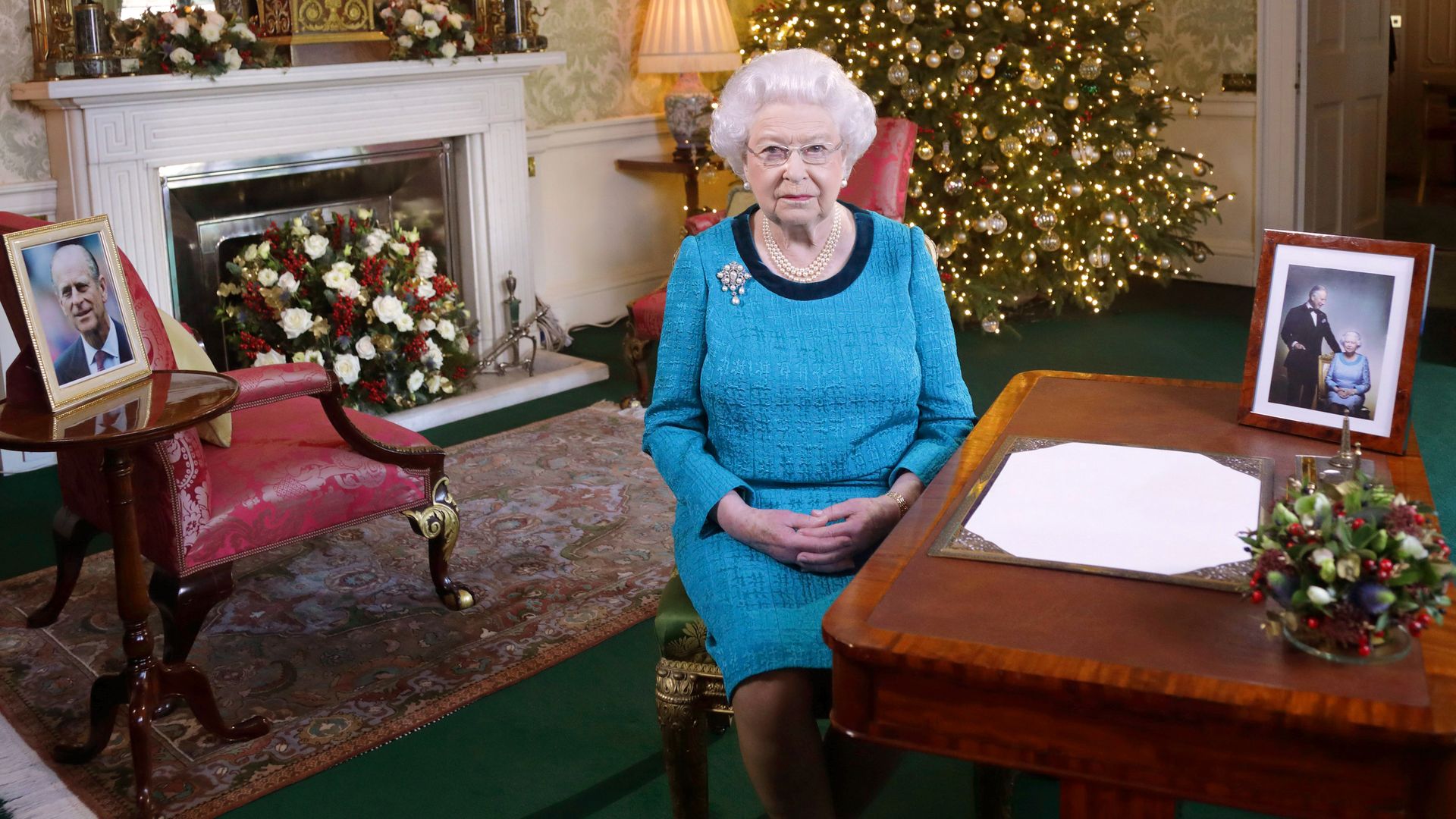 The late Queen sat in the Regency Home with pictures of Prince Philip and a Christmas tree