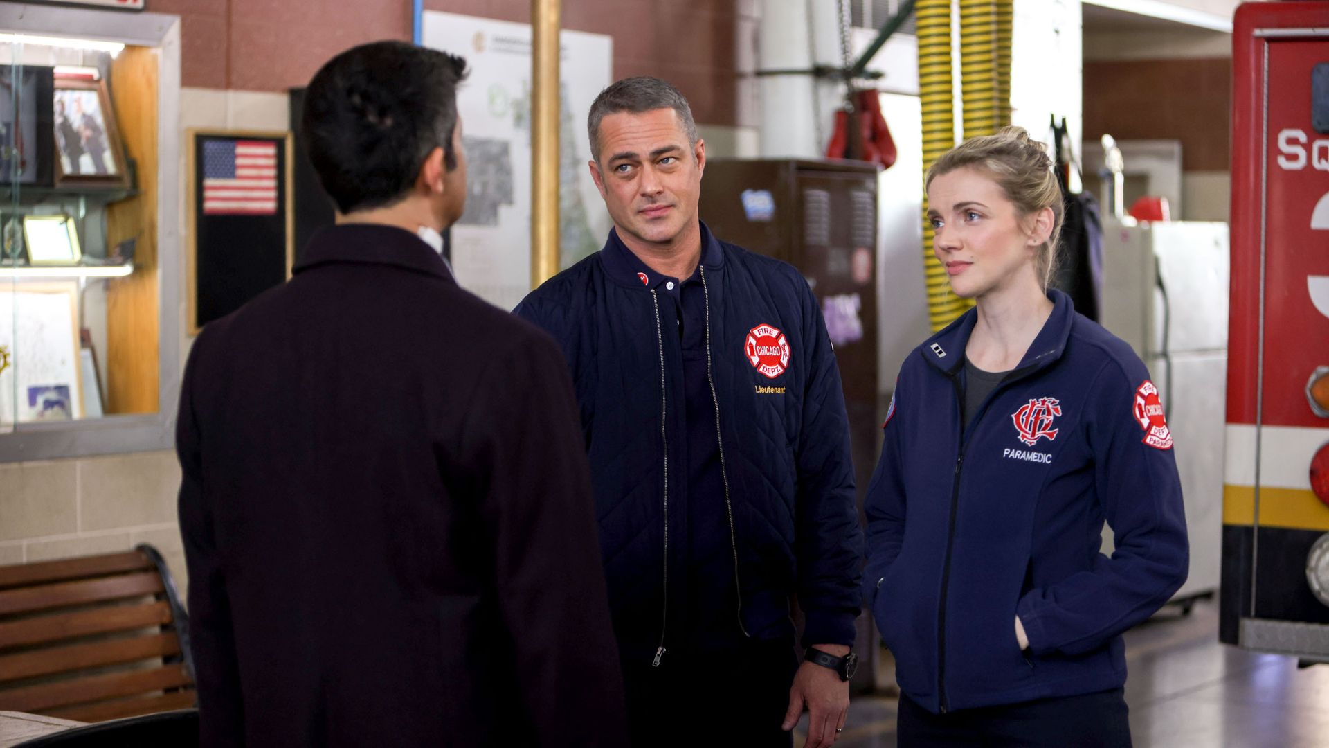 CHICAGO FIRE -- "The Man of the Moment" Episode 1113 -- Pictured: (l-r) Assaf Cohen as Alexander, Taylor Kinney as Kelly Severide, Kara Killmer as Sylvie Brett