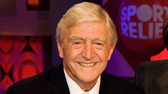 Michael Parkinson sat smiling on a talk show