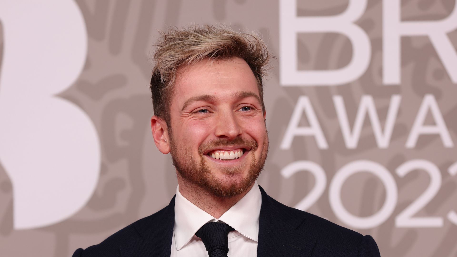 man wearing suit on red carpet