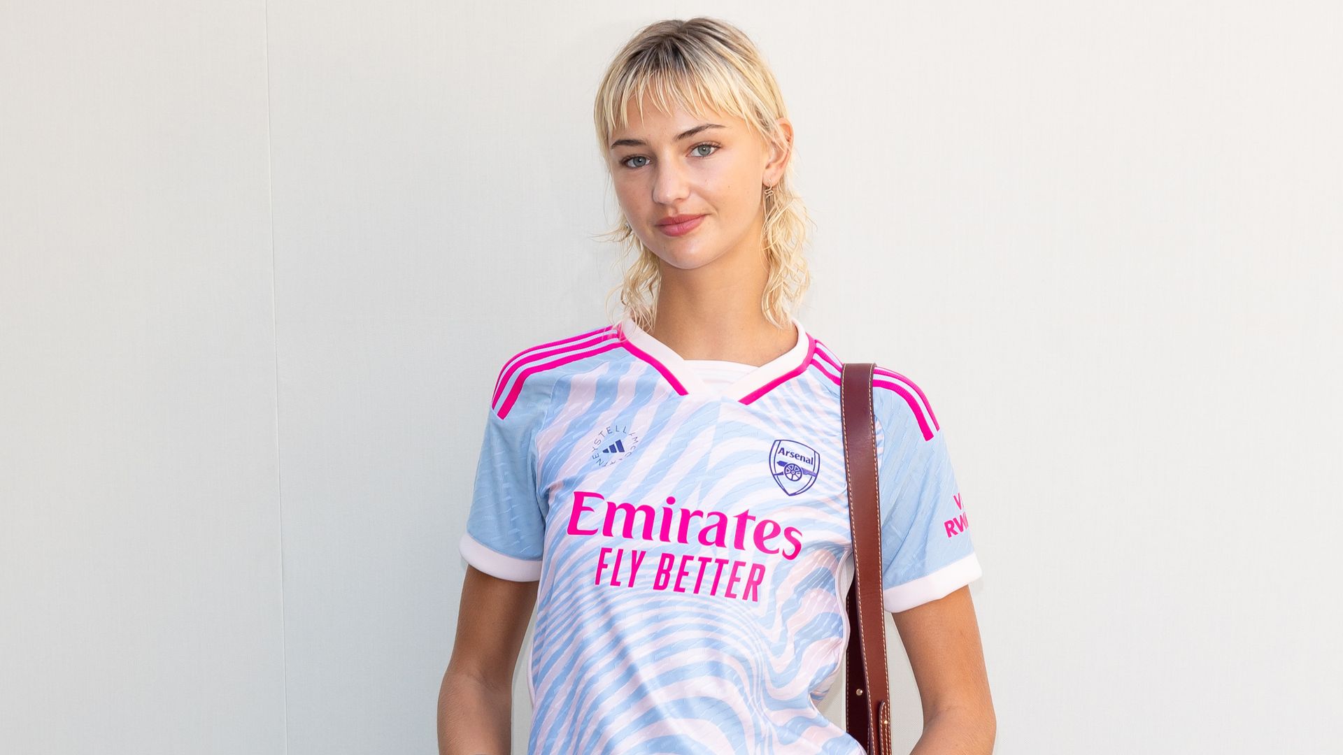 Model Mia Regan attends the Stella McCartney Womenswear Spring/Summer 2024 show as part of Paris Fashion Week in denim skirt and brown boots