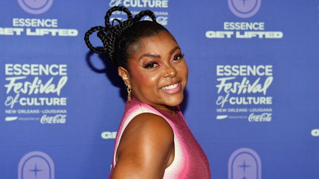 Teraji P. Henson wearing a pink dress and smiling at the camera. 