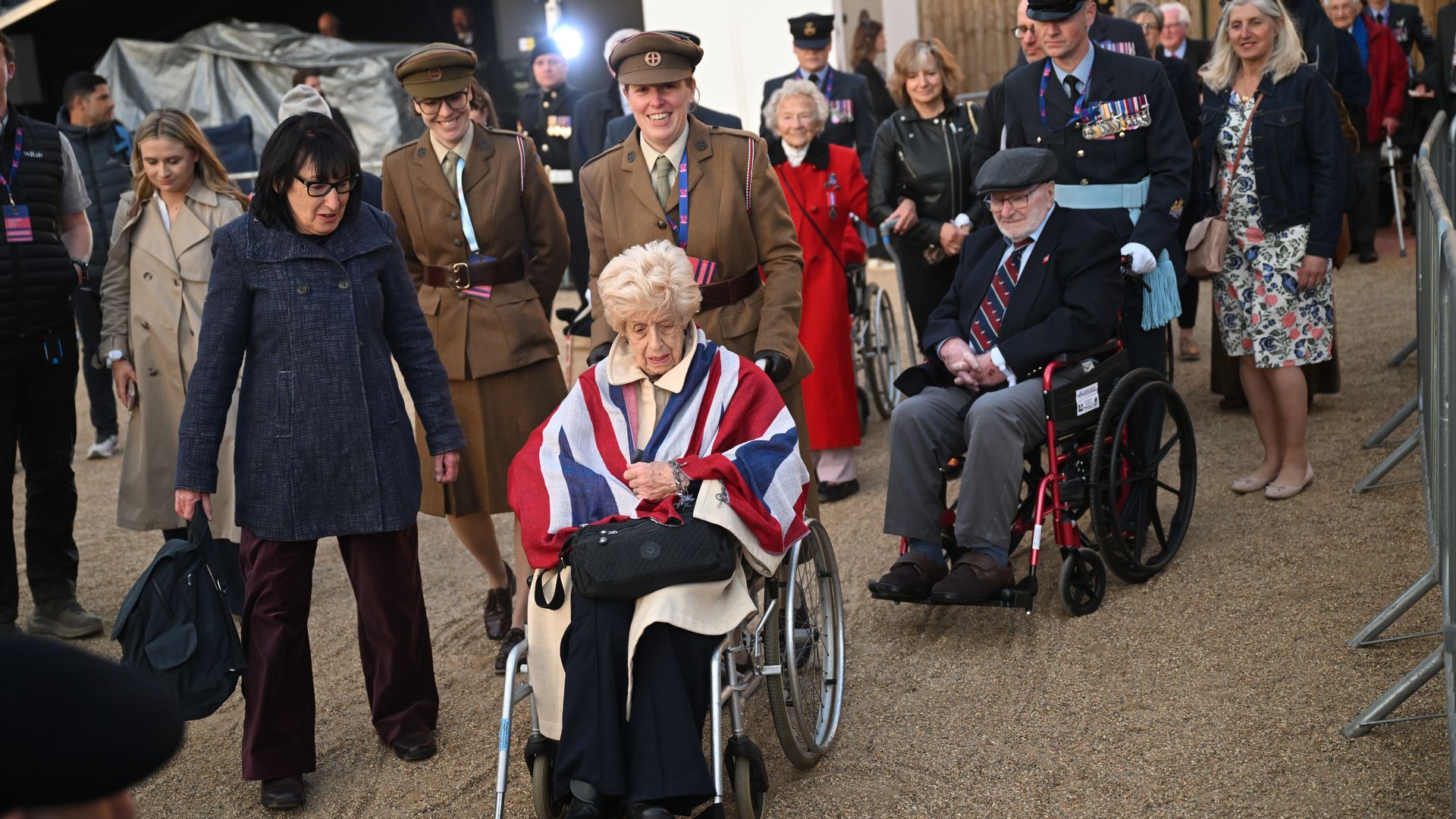 Elderly people in wheelchairs being pushed