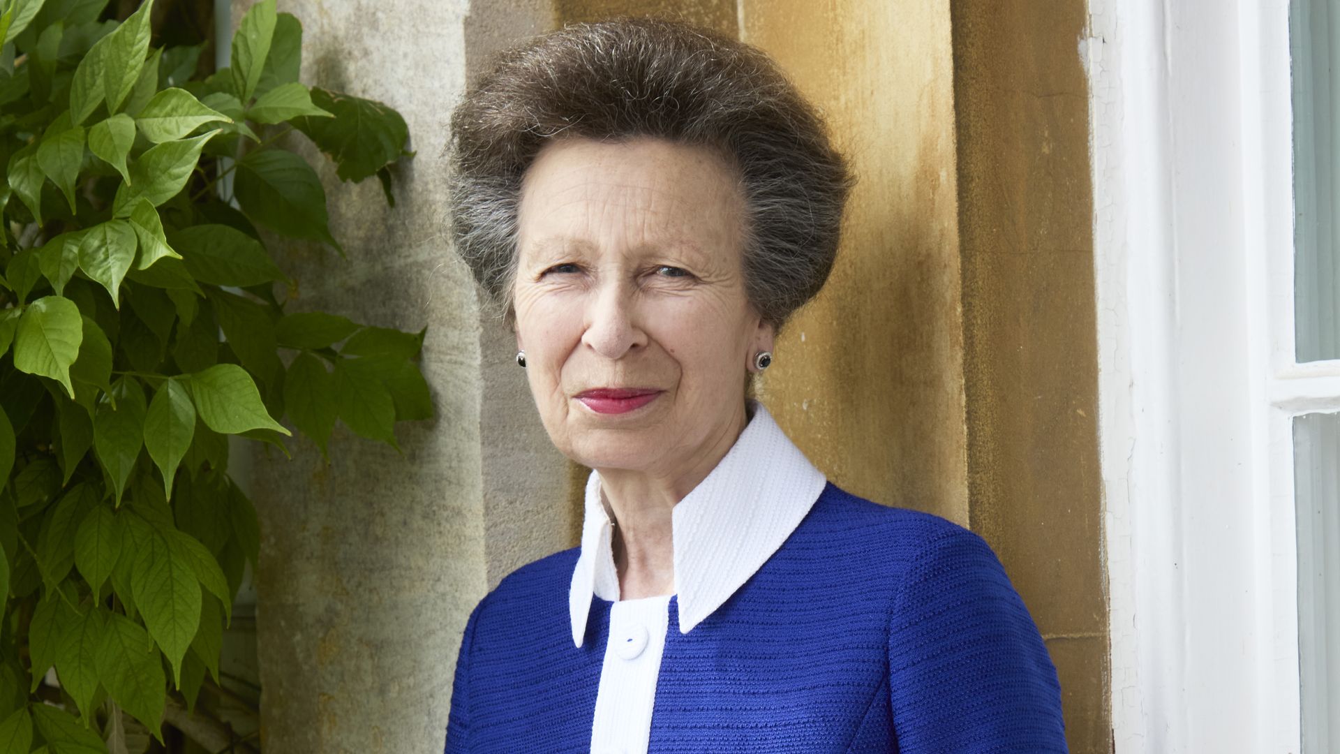 Princess Anne pictured in blue dress outside Gatcombe Park 
