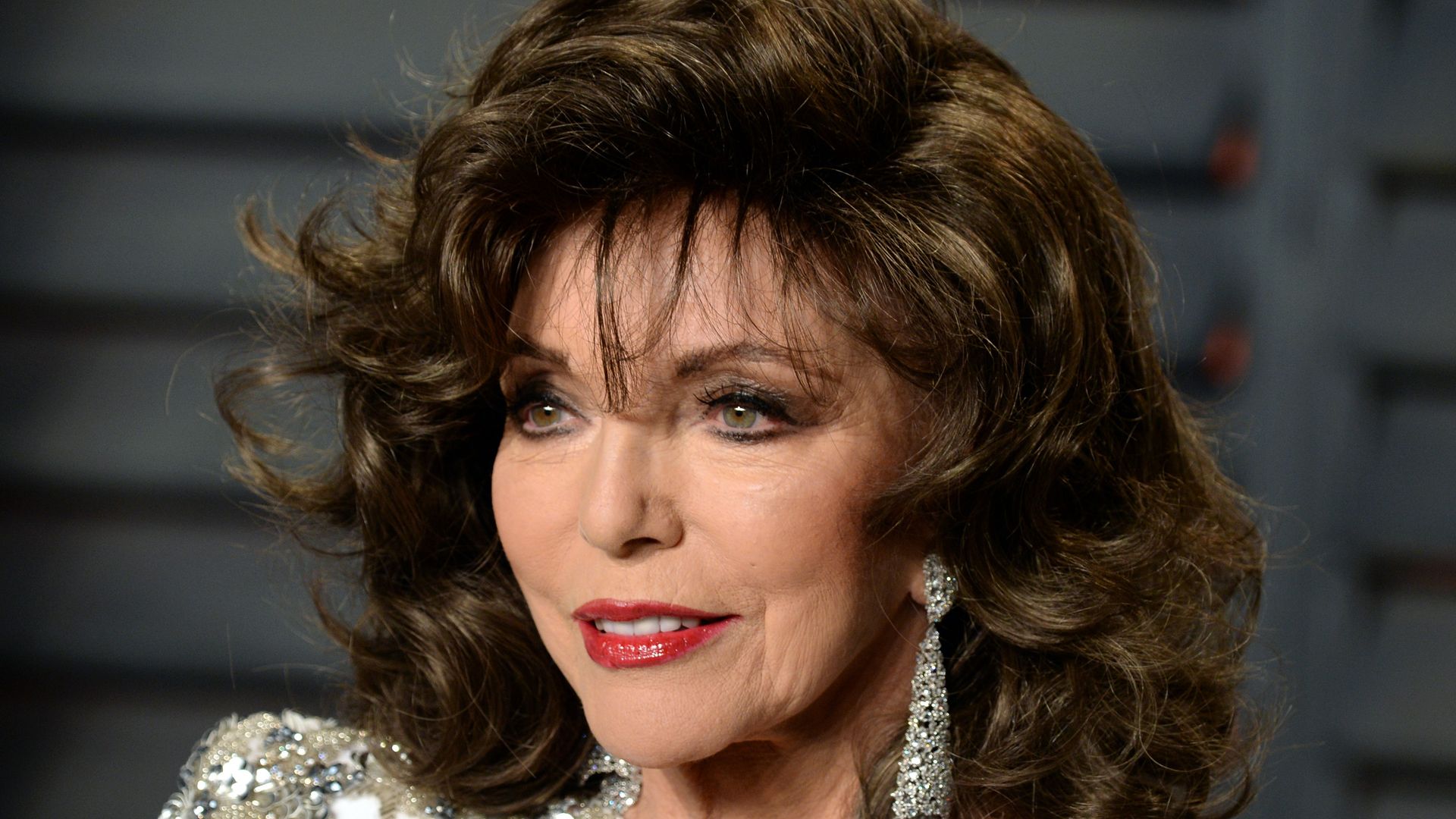 Joan Collins, 91, looks flawless in edgy flares and sporty cap